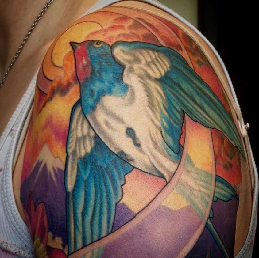 colour tattoo of a blue bird in flight alphonse mucha style tattoo