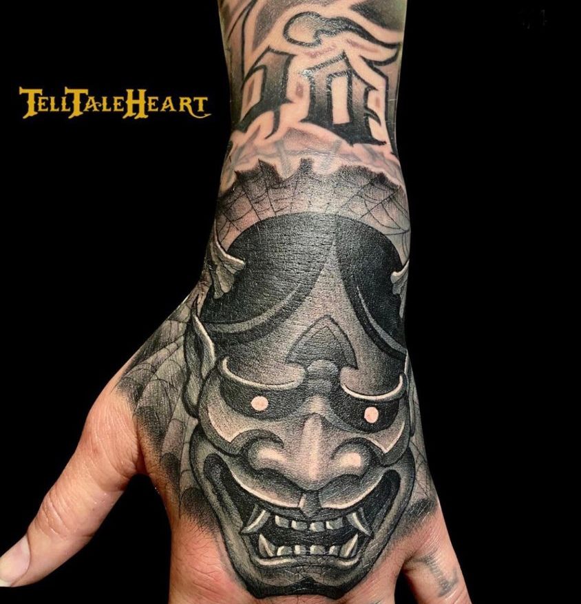 black and grey hanya mask hand tattoo