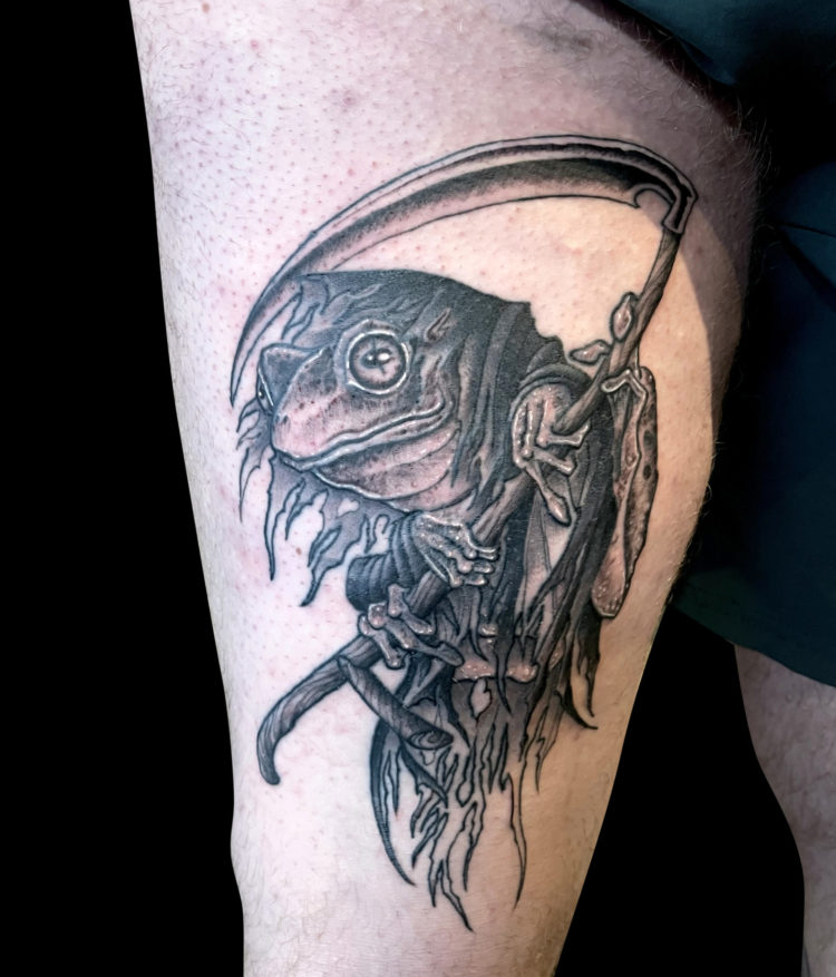 black and grey tattoo of frog as grim reaper with tattered robes holding a scythe