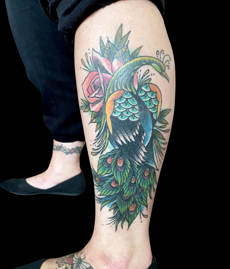 color tattoo of peacock with rose on outside of calf - covering up an older tattoo