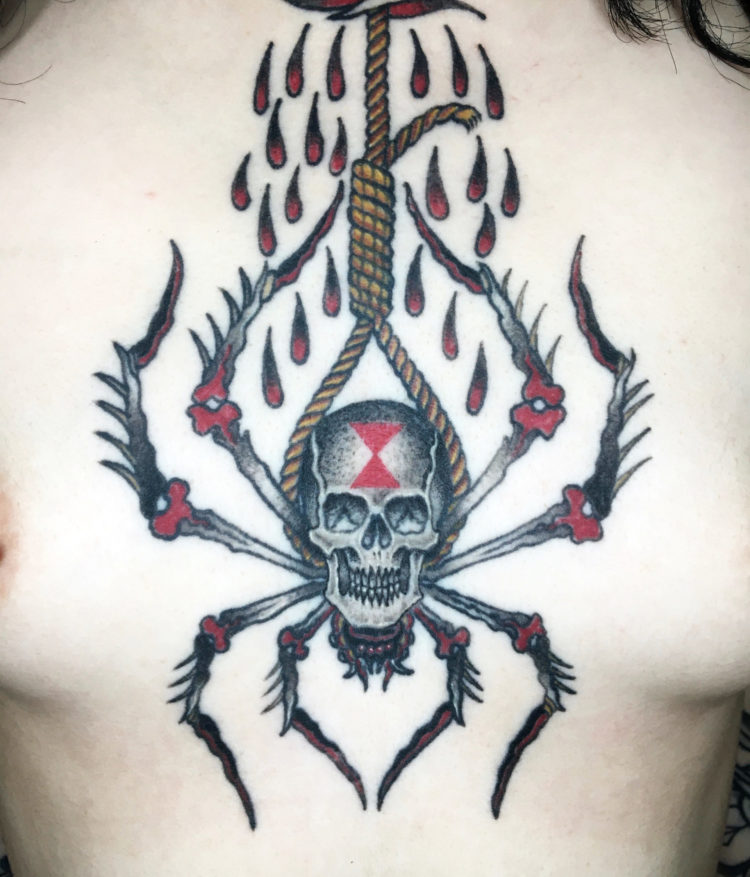 Traditional tattoo of black widow spider with skull body hanging from a noose tattooed on chest
