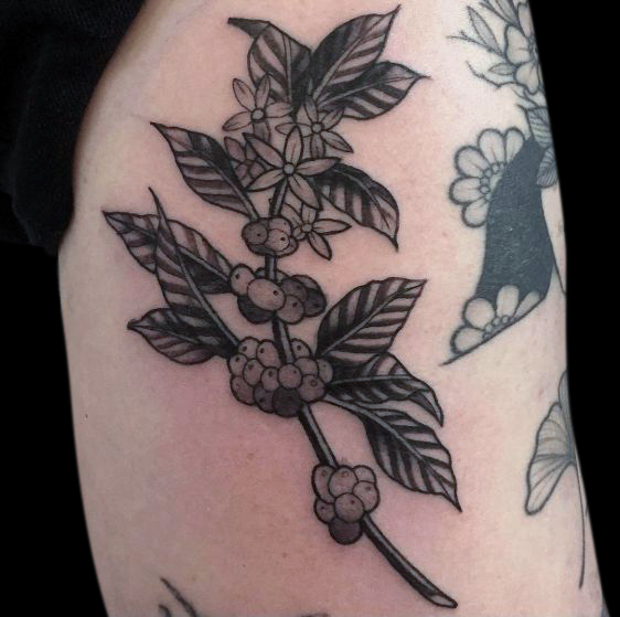 black and grey simple floral branch tattoo with clumps of flowers and large leaves