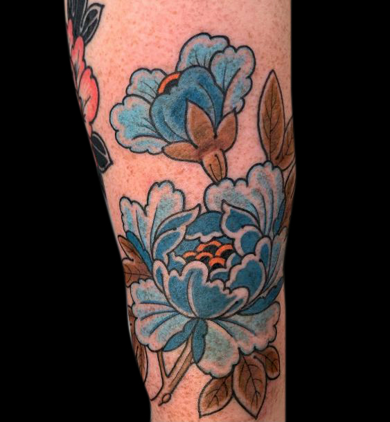 colour tattoo of two blue flowers and brown leaves