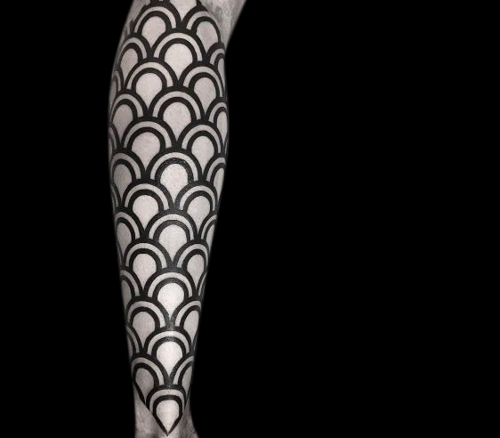 blackwork geometric tattoo of black scales on entire forearm