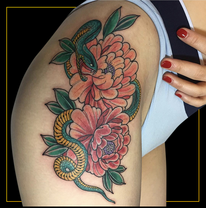 japanese floral hip tattoo with pink flowers and green and yellow snake