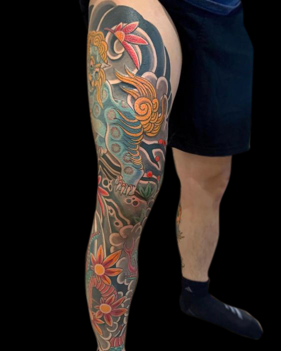 Japanese tradition leg sleeve tattoo of green oni, snake, wind bars, clouds, japanese maple leaves