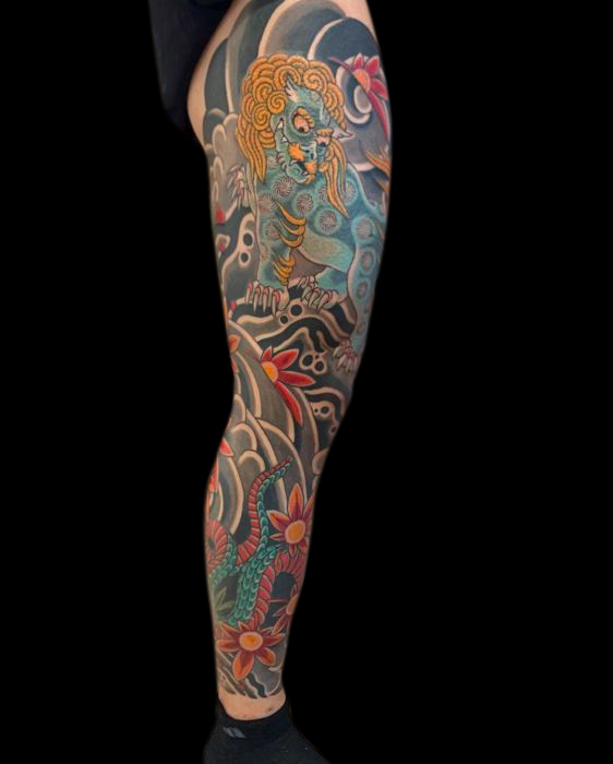 Japanese tradition leg sleeve tattoo of green oni, snake, wind bars, clouds, japanese maple leaves