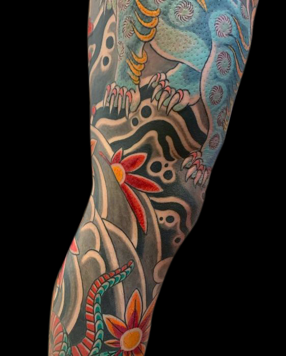 detail of Japanese traditional leg tattoo sleeve wind bars, rocks and Japanese maple leaf