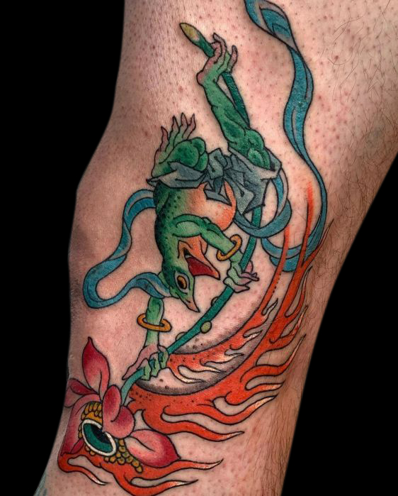 color japanese green frog tattoo dressed as a samurai riding a flaming flower
