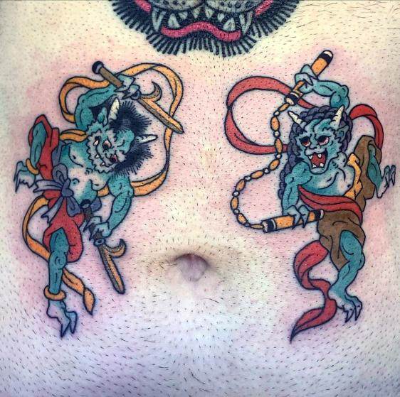 two colour Japanese oni creatures in green wearing red robes brandishing weapons tattooed on stomach