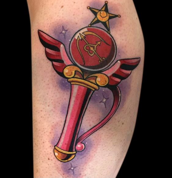colour neotraditional tattoo of red and yellow sailor moon wand
