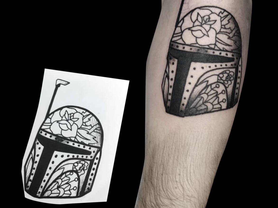 blackwork tattoo of Boba Fett helmet with floral design on forearm