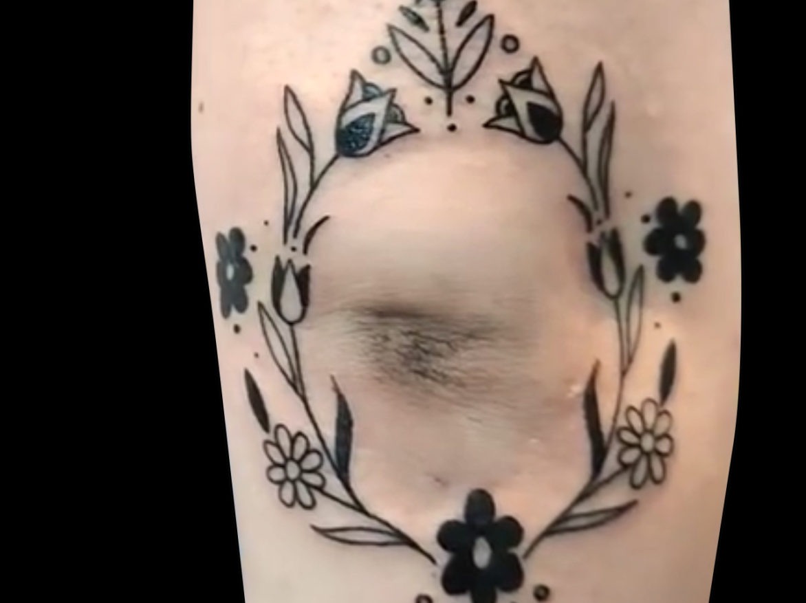 blackwork floral tattoo circle simple flowers tattooed around elbow