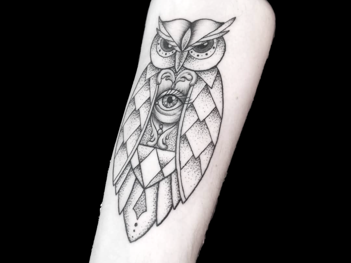 dotwork tattoo of owl design with an eye in the middle of its chest shaded with dots