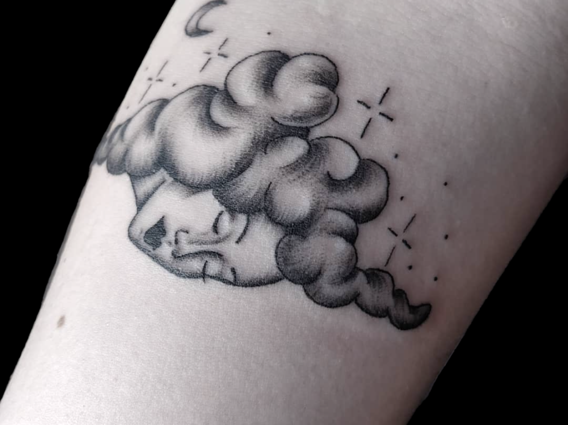 fineline tattoo of a lady face coming out of a could with simple stars and move above