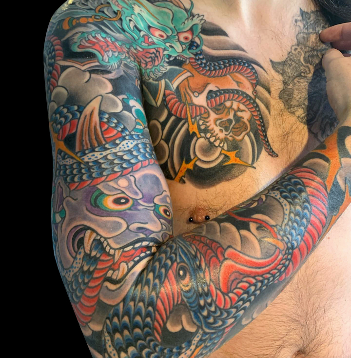 Colour Japanese tattoo sleeve of demons including hanya, oni and snake with black wind bars