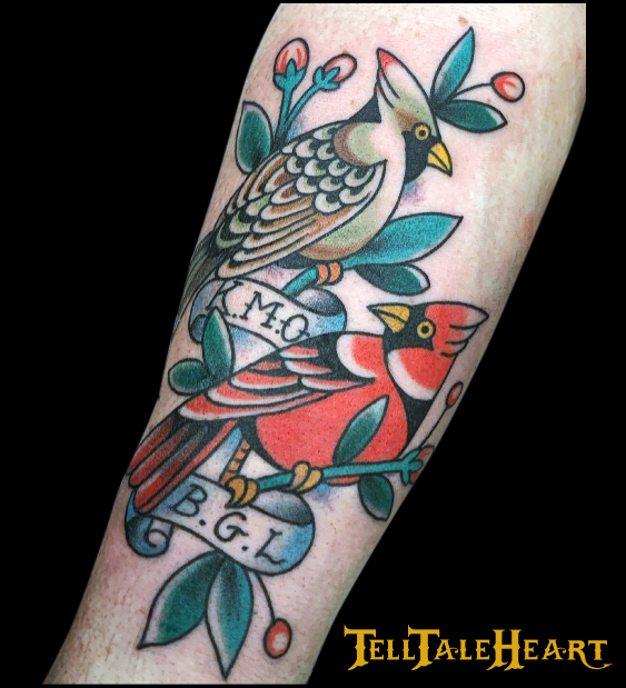 traditional colour tattoo of a female and male cardinal with a banner featuring initials