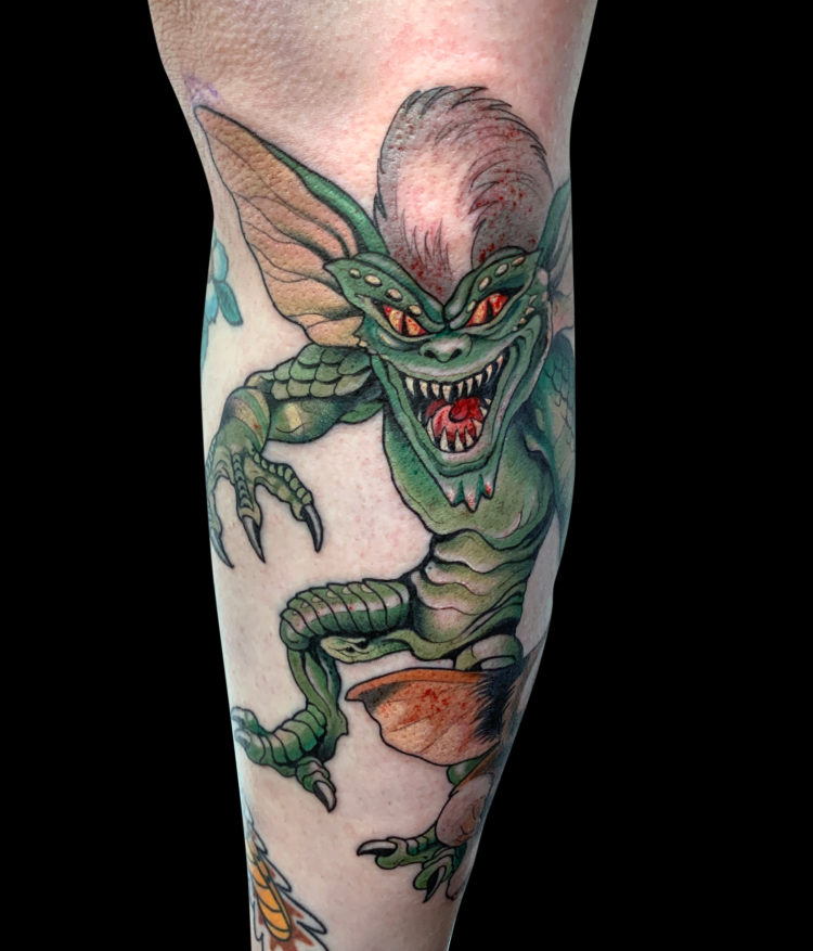 Colour tattoo of Gremlins characters Spike and Gizmo tattooed on leg