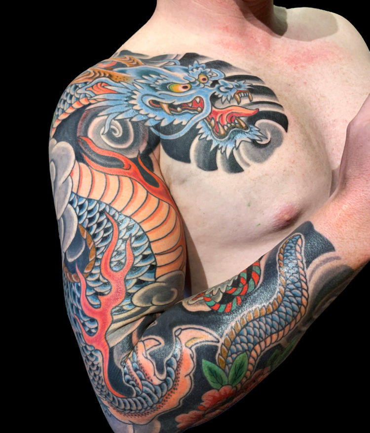 Colour Japanese dragon tattoo sleeve featuring blue dragon, flames and wind bars