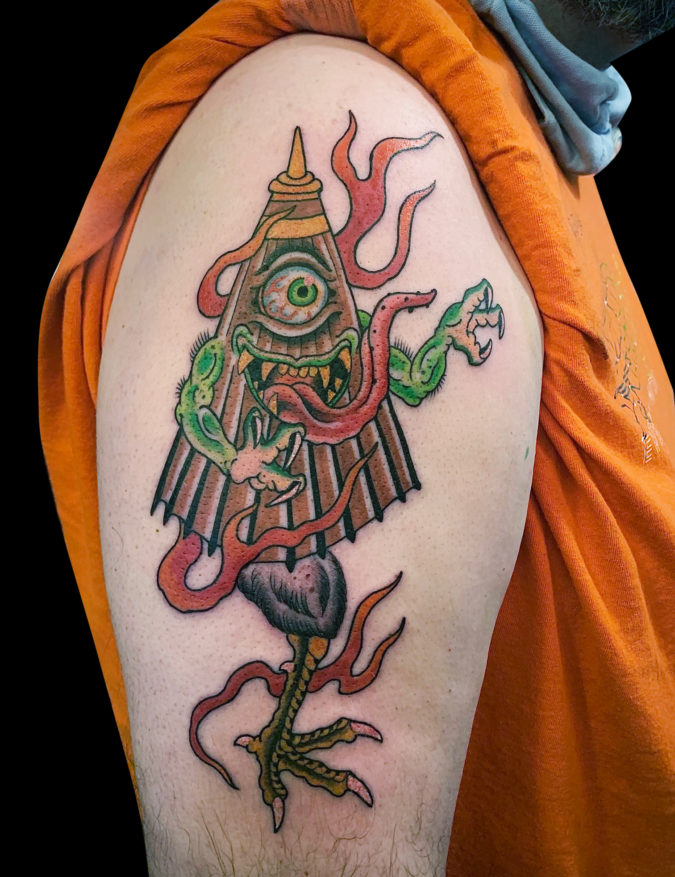 colour tattoo of Japanese Kasa-obake umbrella monster with on eye, long tongue, one chicken leg and monster claw arms