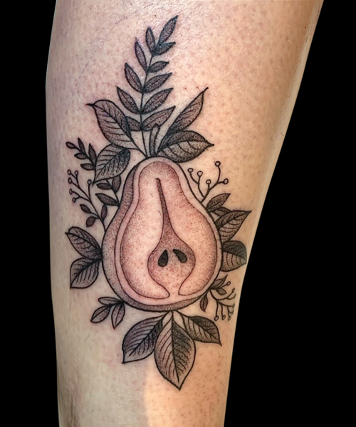 illustrative tattoo of halved pear with leaves done with dotwork and black fine lines