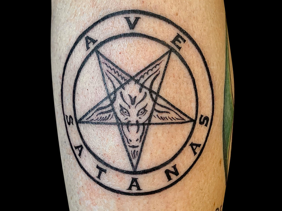 black pentagram tattoo with goat head design inside two concentric circles with texts that reads AVE SATANAS